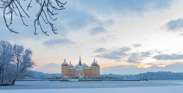 Moritzburg Castle covered in snow in winter.