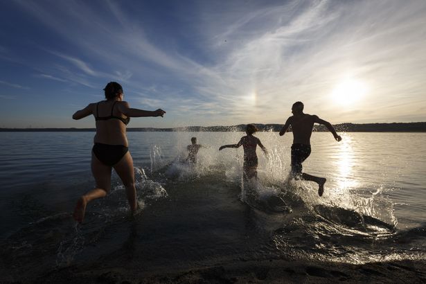 Familie rennt in Wasser zum baden